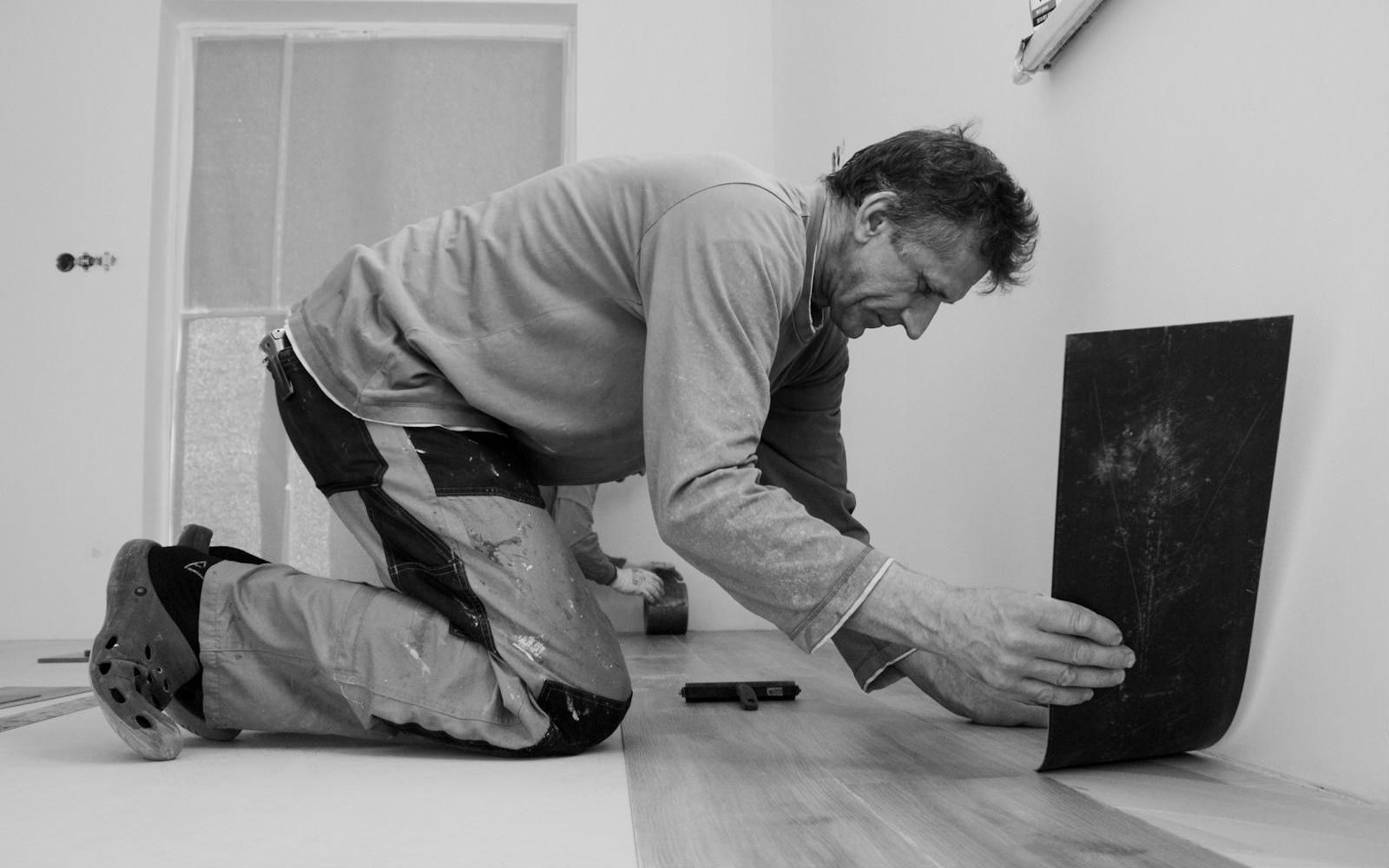 Installer laying new plank flooring